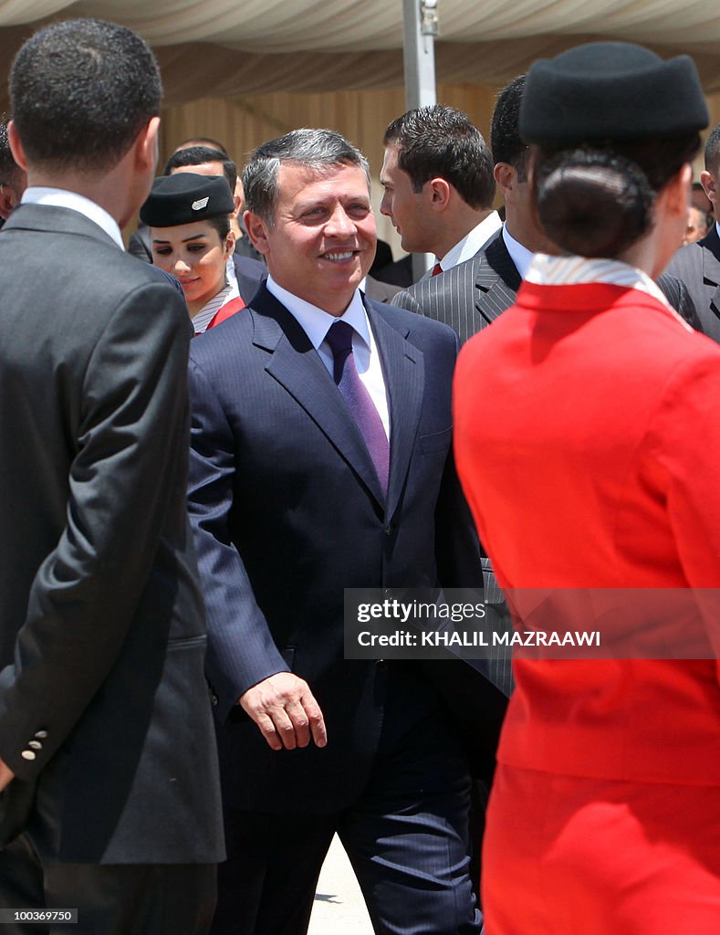 Jordan's King Abdullah II walks past fli