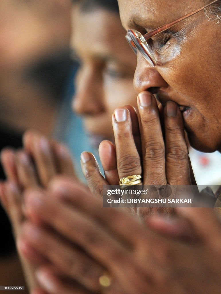 Relatives and mourners attend a funeral