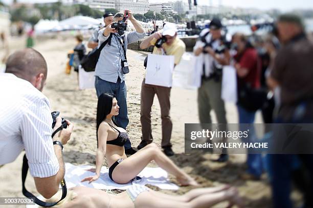 Hungarian model and actress Aletta Ocean poses in bikini on the beach during a photocall on the sidelines of the 63rd Cannes Film Festival on May 18,...