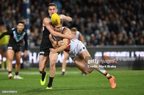 Tom Rockliff of Port Adelaide competes with Phil Davis of the Giants during the round 18 AFL match between the Port Adelaide Power and the Greater...