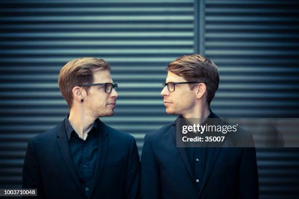 twin brothers face to face portrait - same person different outfit stock pictures, royalty-free photos & images