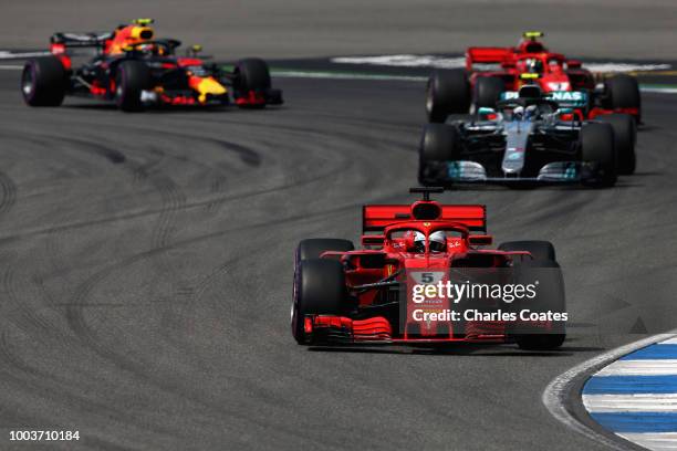 Sebastian Vettel of Germany driving the Scuderia Ferrari SF71H leads Valtteri Bottas driving the Mercedes AMG Petronas F1 Team Mercedes WO9 on track...