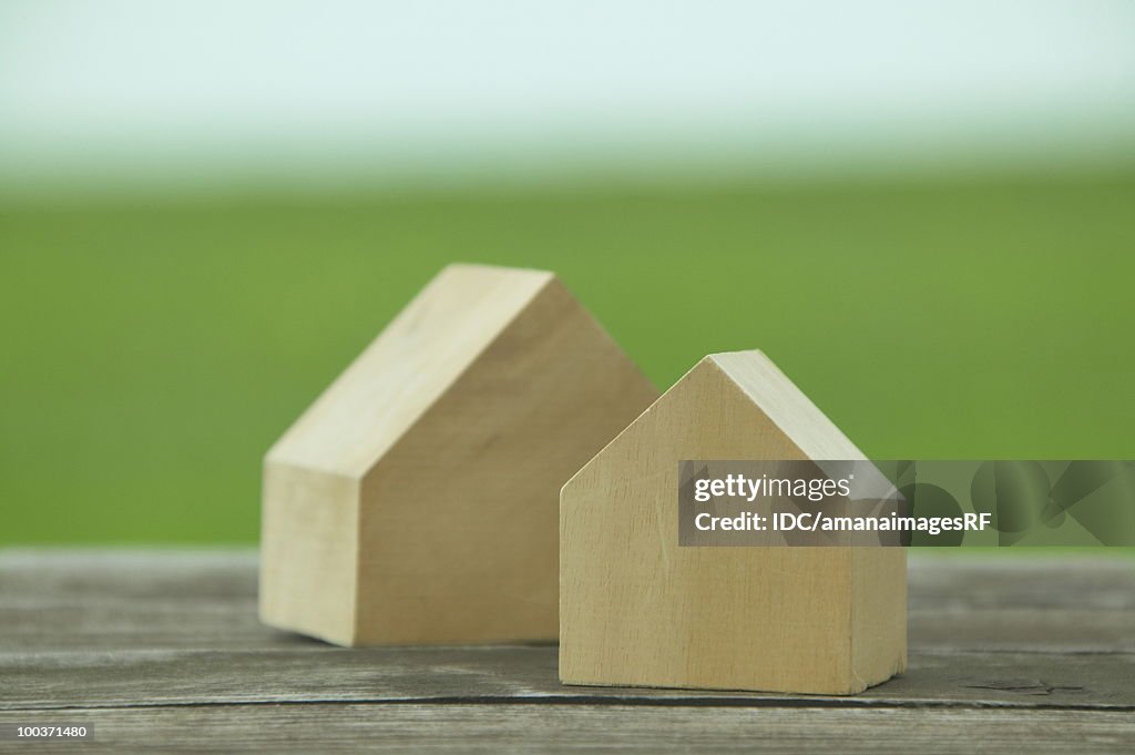 Wooden model houses in the field, differential focus