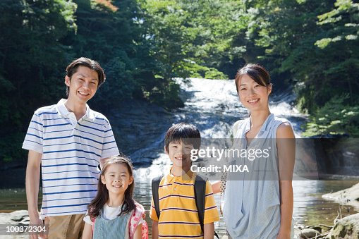 Family Standing by Mountain Stream Family Standing by Mountain Stream