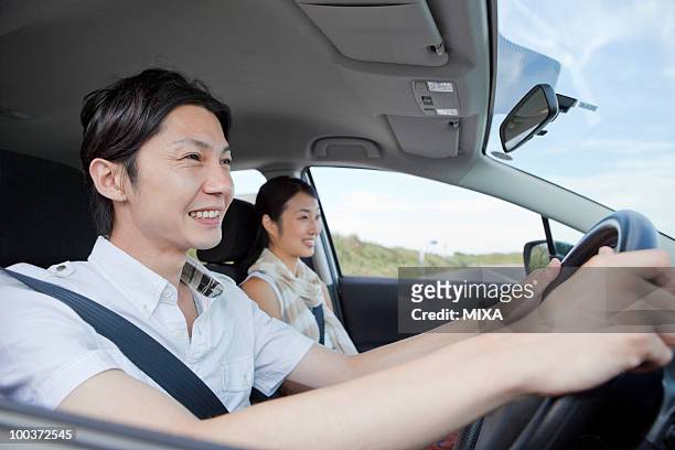 young couple going for a drive - asian couple car stock pictures, royalty-free photos & images