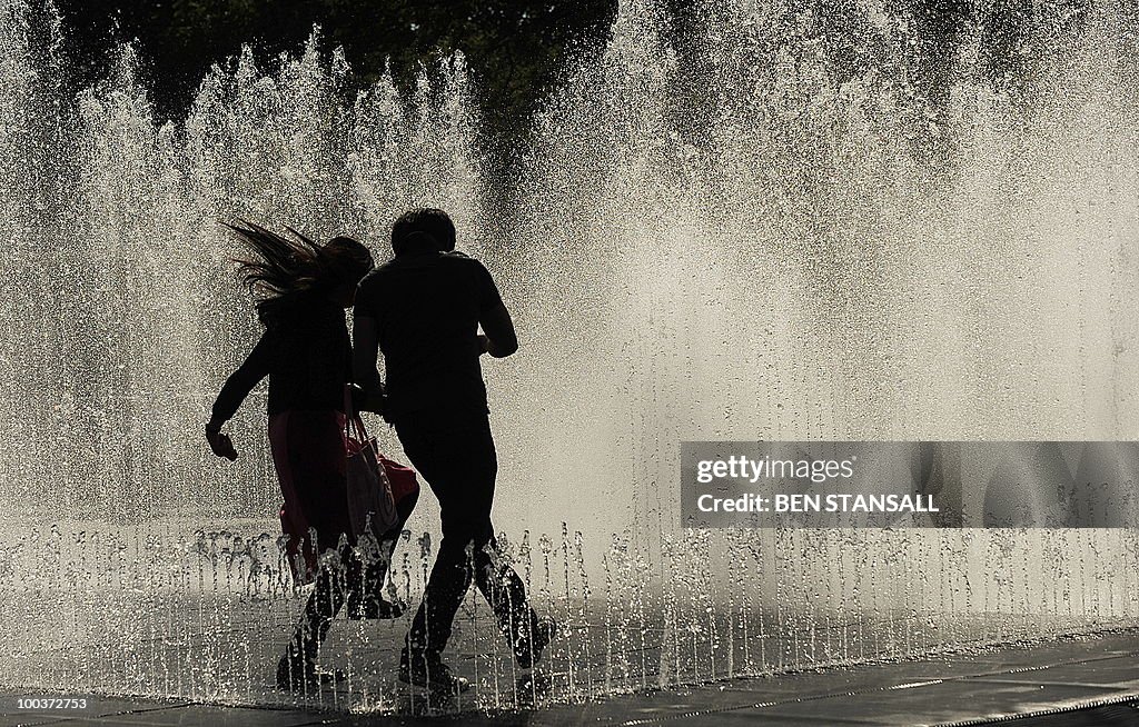 A couple enjoy the fountains outside the