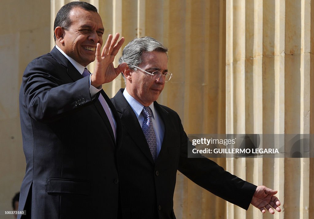 Honduran President Porfirio Lobo (L) wav