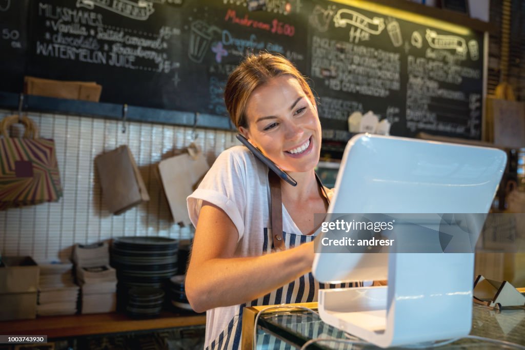 Waitress talking on the phone at a restaurant