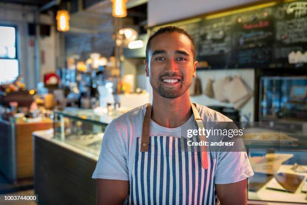 happy waiter working at a restaurant - aboriginal man stock pictures, royalty-free photos & images