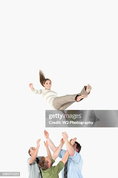 businesspeople catching falling woman - safety netting stock pictures, royalty-free photos & images