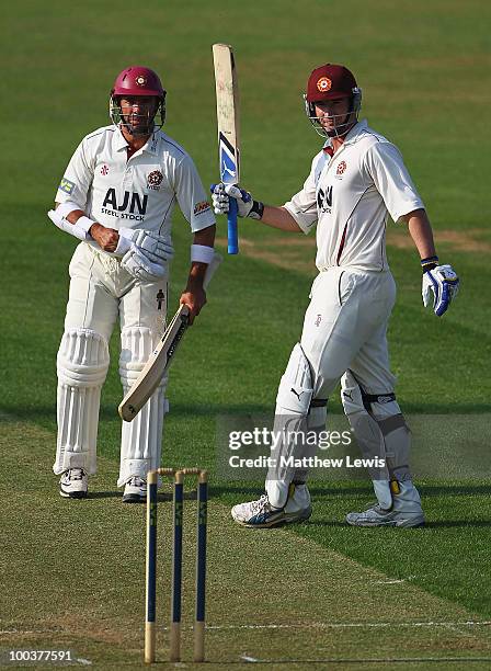 Nicky Boje of Northamptonshire congratulates Mal Loye on his century during the LV County Championship match between Northamptonshire and Surrey at...