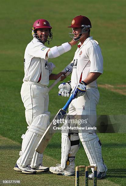 Nicky Boje of Northamptonshire congratulates Mal Loye on his century during the LV County Championship match between Northamptonshire and Surrey at...