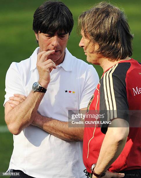 Germany's head coach Joachim Loew talks with team doctor Hans Wilhelm Mueller-Wohlfahrt during a training match against Sued Tyrol FC at the team's...