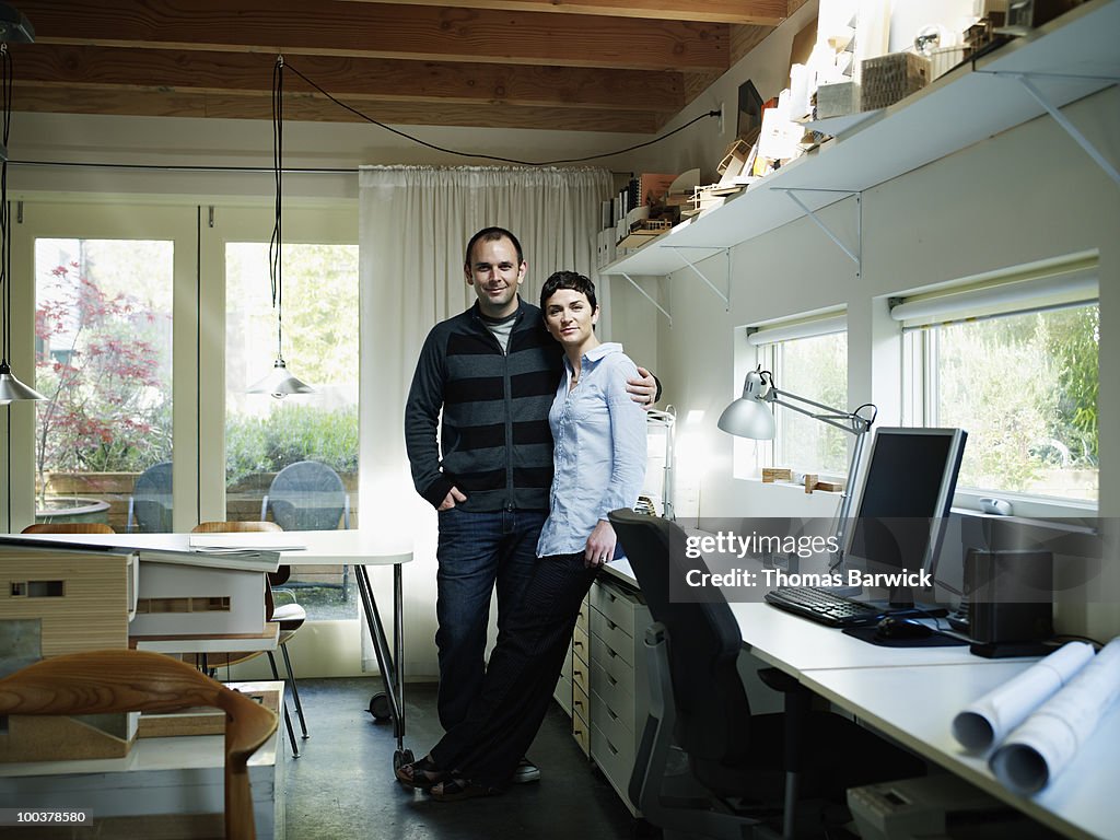 Husband and wife architect team in home office