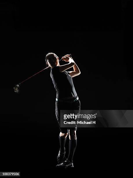 the lady golfer swings the driver of golf - golf swing stock-fotos und bilder