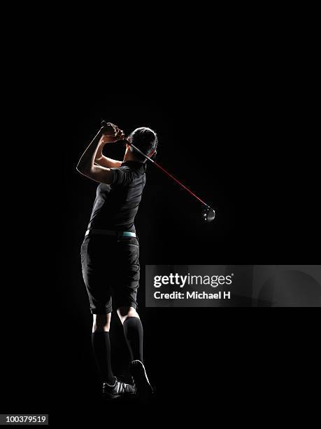 the lady golfer swings the driver of golf - woman on swing foto e immagini stock