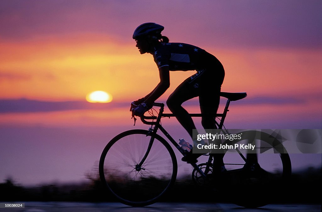 SILHOUETTE OF AN US CYCLING TEAM RIDER AT SUNSET IN SOUTH CALIFORNIA