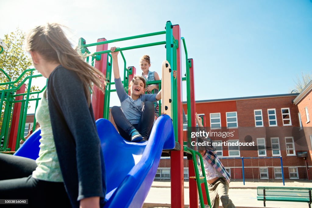 Group of kids active in school playground at recess..