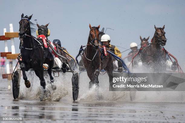 Horse and buggy teams compete in the annual horse buggy races on the mudflats at Duhnen on July 22, 2018 in Cuxhaven, Germany. The races, which in...