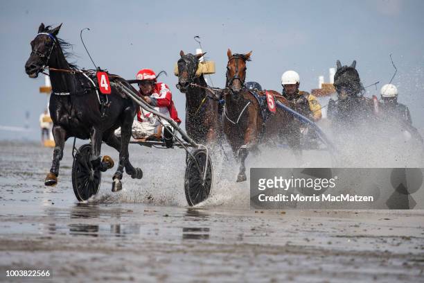 Horse and buggy teams compete in the annual horse buggy races on the mudflats at Duhnen on July 22, 2018 in Cuxhaven, Germany. The races, which in...