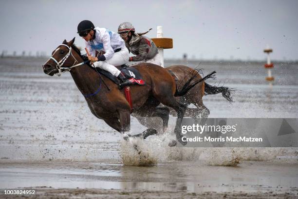 Horses and riders compete in the annual horse buggy races on the mudflats at Duhnen on July 22, 2018 in Cuxhaven, Germany. The races, which in German...