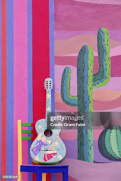 painted guitar, chair & wall in cancun, mexico - cancun stock illustrations