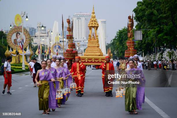 Thais parade in a procession comprising symbols of Buddhism to mark Asanha Bucha Day in Bangkok, Thailand, 22 July 2018.