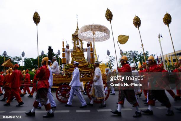 Thais parade in a procession comprising symbols of Buddhism to mark Asanha Bucha Day in Bangkok, Thailand, 22 July 2018.