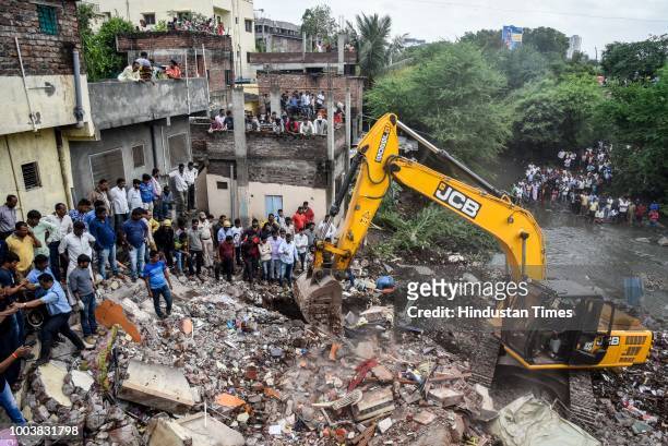 Fire brigade officers and locals try to rescue animals after rescuing 8 people were trapped as a wall of a two-storey residential building collapsed...