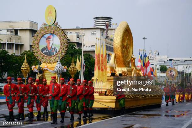 Thais parade in a procession comprising symbols of Buddhism to mark Asanha Bucha Day in Bangkok, Thailand, 22 July 2018.