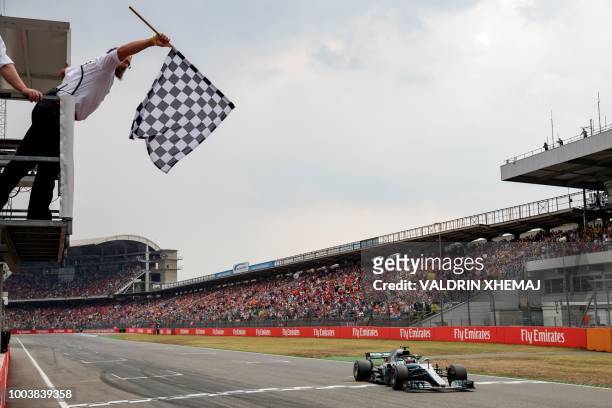 British Formula One driver Lewis Hamilton of Mercedes AMG GP crosses the finish line during the German Formula One Grand Prix at the Hockenheim...