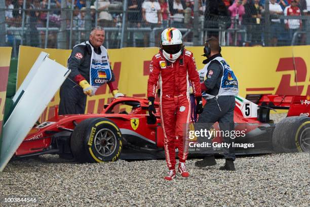 Sebastian Vettel of Germany and Ferrari walks from his car after crashing during the Formula One Grand Prix of Germany at Hockenheimring on July 22,...