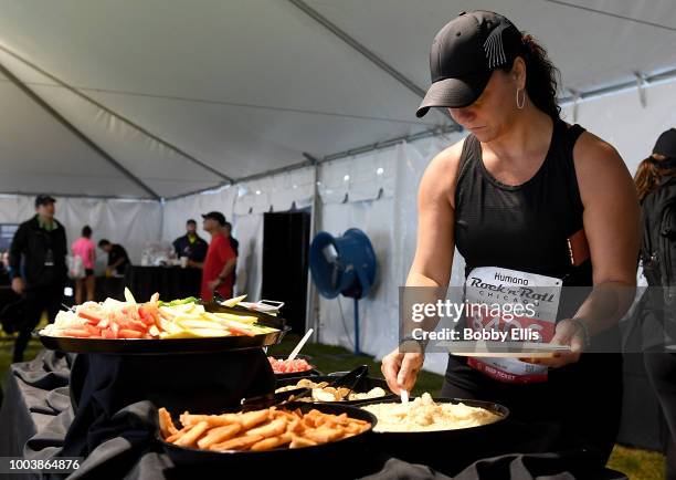 Runner gets food in the Westin VIP tent following the Rock "n" Roll Half Marathon and 10K on July 22, 2018 in Chicago, Illinois.