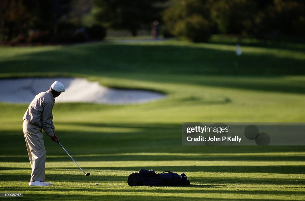 MAN PLAYING GOLF