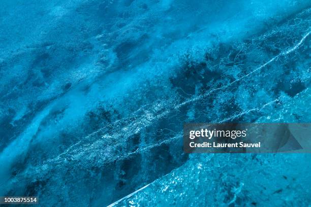 blue abstract background containing cracks and complex shapes in the glacier ice of the mer de glace ice cave, chamonix-mont-blanc, france - ice cave imagens e fotografias de stock