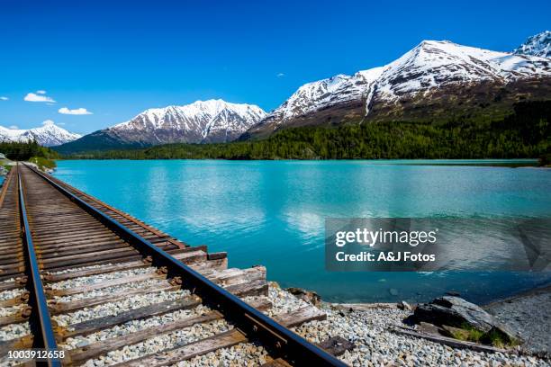 railroad track with lake and mountain range - alaska location stock pictures, royalty-free photos & images