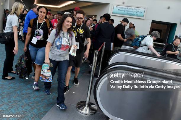 Fans head down the escalator to attend Preview Night during the San Diego Comic-Con at the San Diego Convention Center in San Diego on Wednesday,...