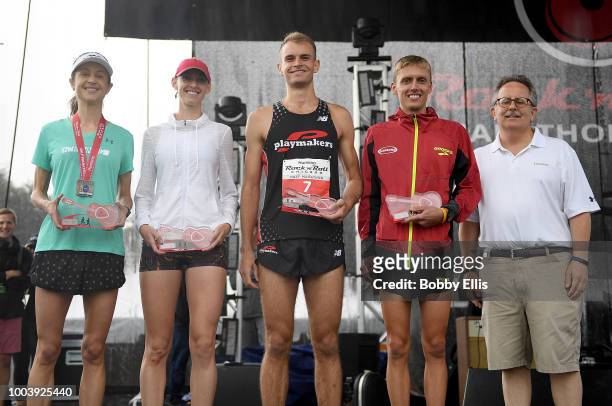 The top male and female finishers of the Rock "n" Roll Chicago Half Marathon pose for a photo during an award ceremony following the race on July 22,...
