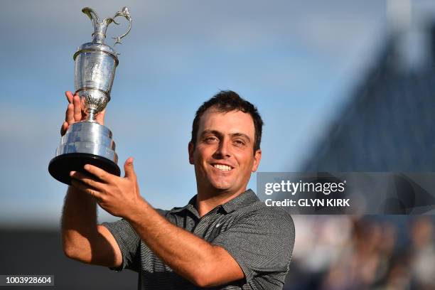 Italy's Francesco Molinari poses for pictures with the Claret Jug, the trophy for the Champion golfer of the year after winning the 147th Open golf...