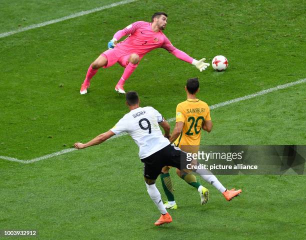 Australia's goalkeeper Maty Ryan and teammate Trent Sainsbury attempt to block a shot on goal by Germany's Sandro Wagner during the Confederations...