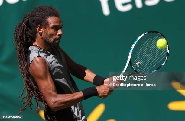 German tennis player Dustin Brown in action during the ATP tennis tournament match against his Canadian opponent Vasek Pospisil in Halle, Germany, 19...