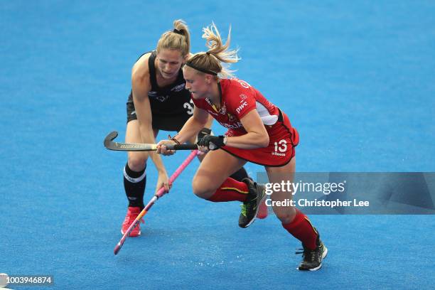 Alix Gerniers of Belgium and Stacey Michelsen of New Zealand race for the ball during the Pool D game between New Zealand and Belgium of the FIH...