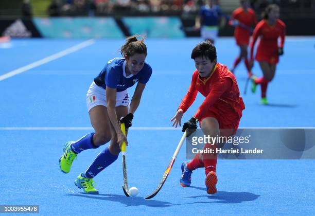 Lara Oviedo of Italy is challenged by Yang Peng of China during the Pool A game between China and Italy of the FIH Womens Hockey World Cup at Lee...