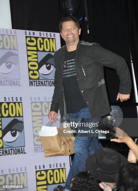 Misha Collins walks onstage at the "Supernatural" special video presentation and Q&A during Comic-Con International 2018 at San Diego Convention...