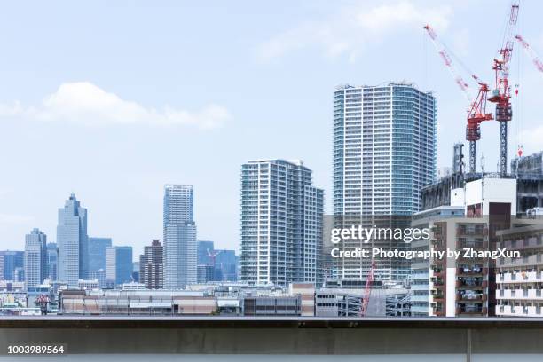 tokyo toyosu cityscape, skyscrapers skyline image with buildings under construction, at day time summer, japan. - toyosu stock pictures, royalty-free photos & images