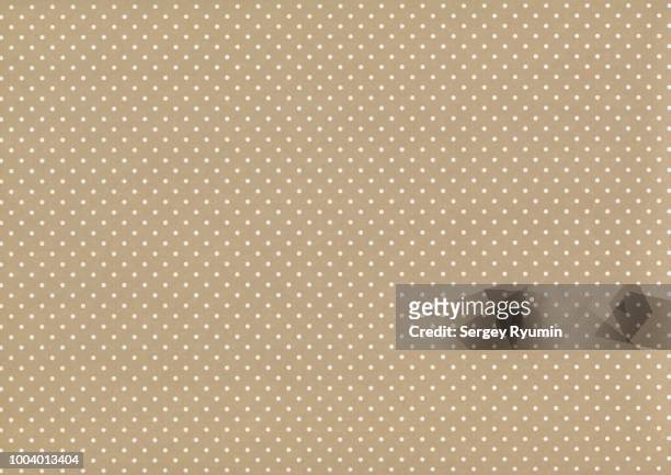 polka dot on beige paper as an abstract background - polka dot stock pictures, royalty-free photos & images