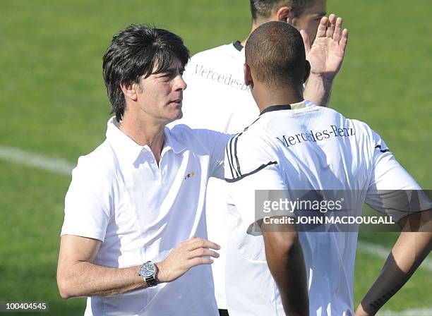 Germany's head coach Joachim Loew speaks to Germany's defender Jerome Boateng prior to a training match Germany against Sued Tyrol FC at the team's...