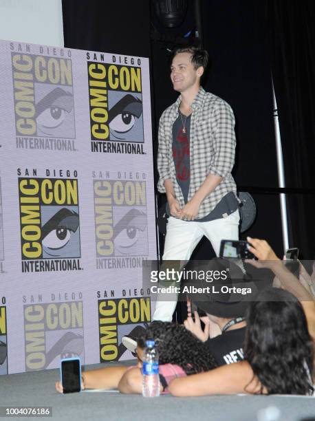 Alexander Calvert walks onstage at the "Supernatural" special video presentation and Q&A during Comic-Con International 2018 at San Diego Convention...
