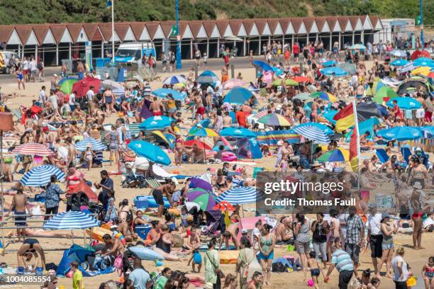 tens of thousands of people crowd the beach in bournemouth, uk - crowded beach stock pictures, royalty-free photos & images