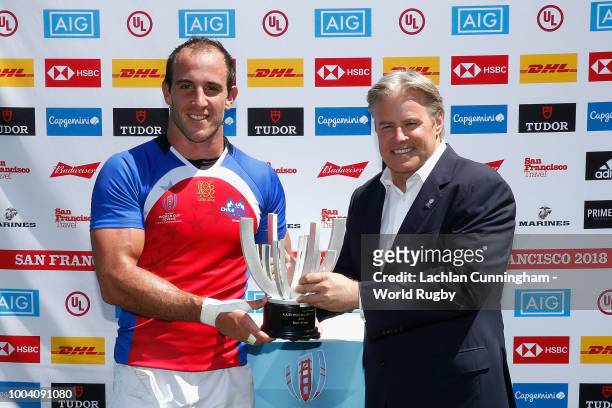 Felipe Brangier of Chile is presented with the Bowl trophy by World Rugby via Getty Images CEO Brett Gosper after defeating Hong Kong during day...